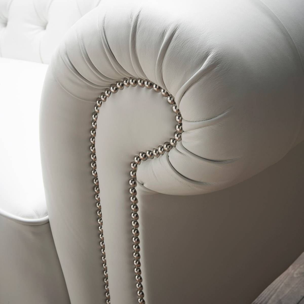Detail of rolled leather arm with studded finishing