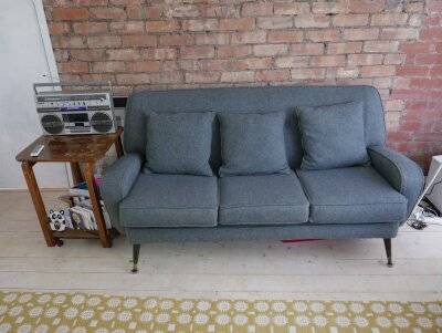 Mid-century three-seater sofa reupholstered in matching charcoal grey