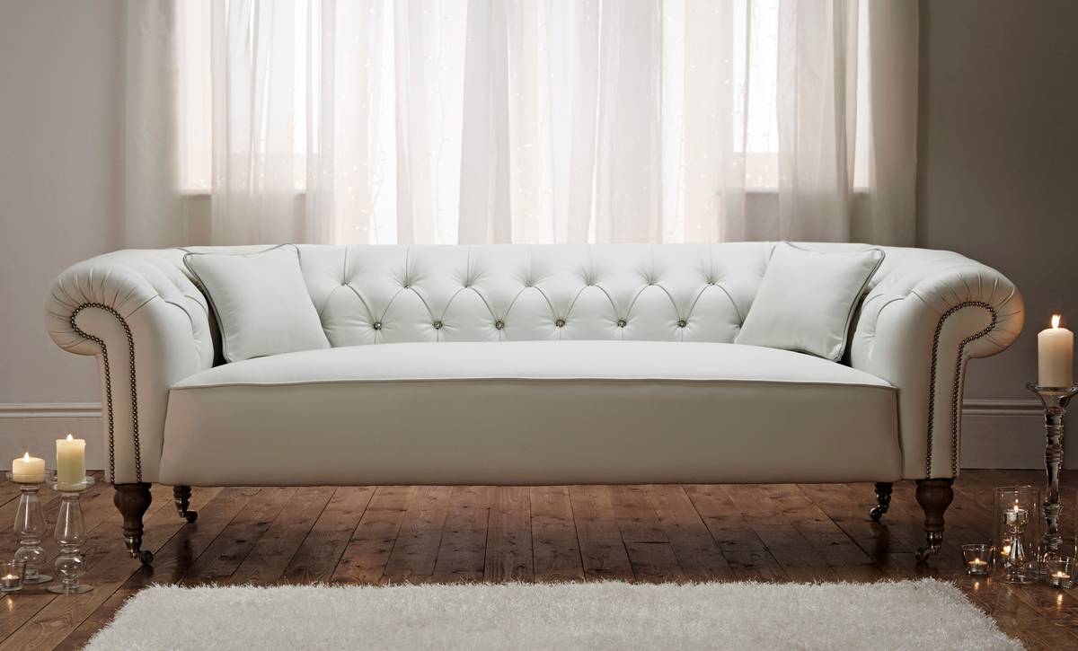 White leather Chesterfield sofa with button tufting and studded arms